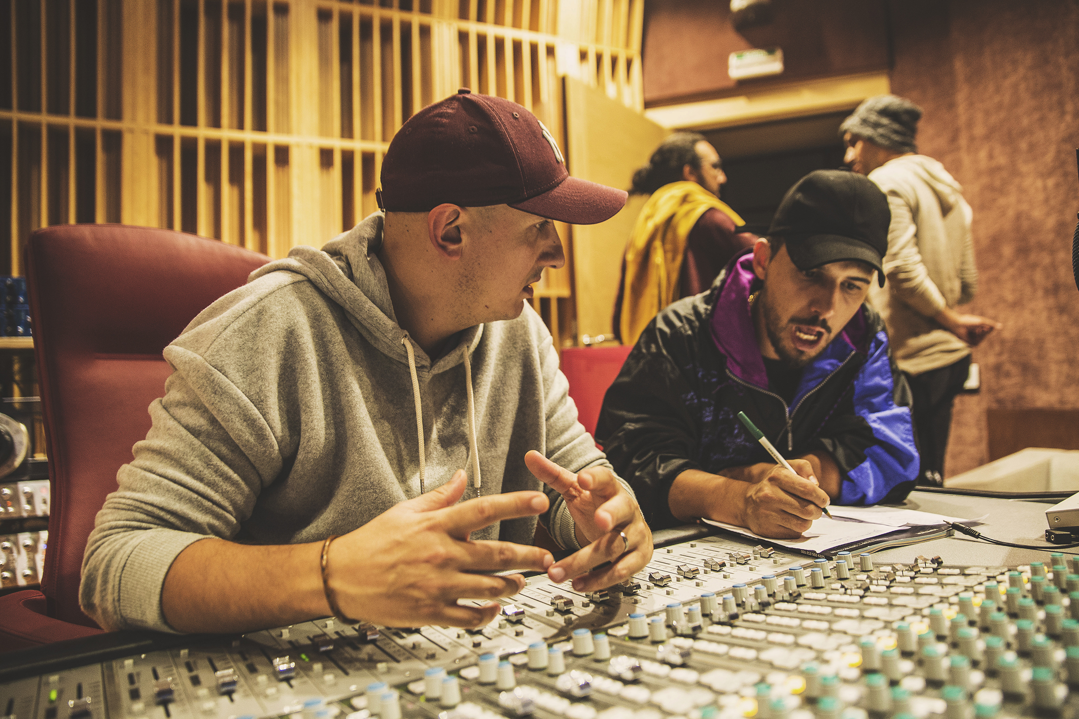 DJ Khalid Music directing a session at the mixing console